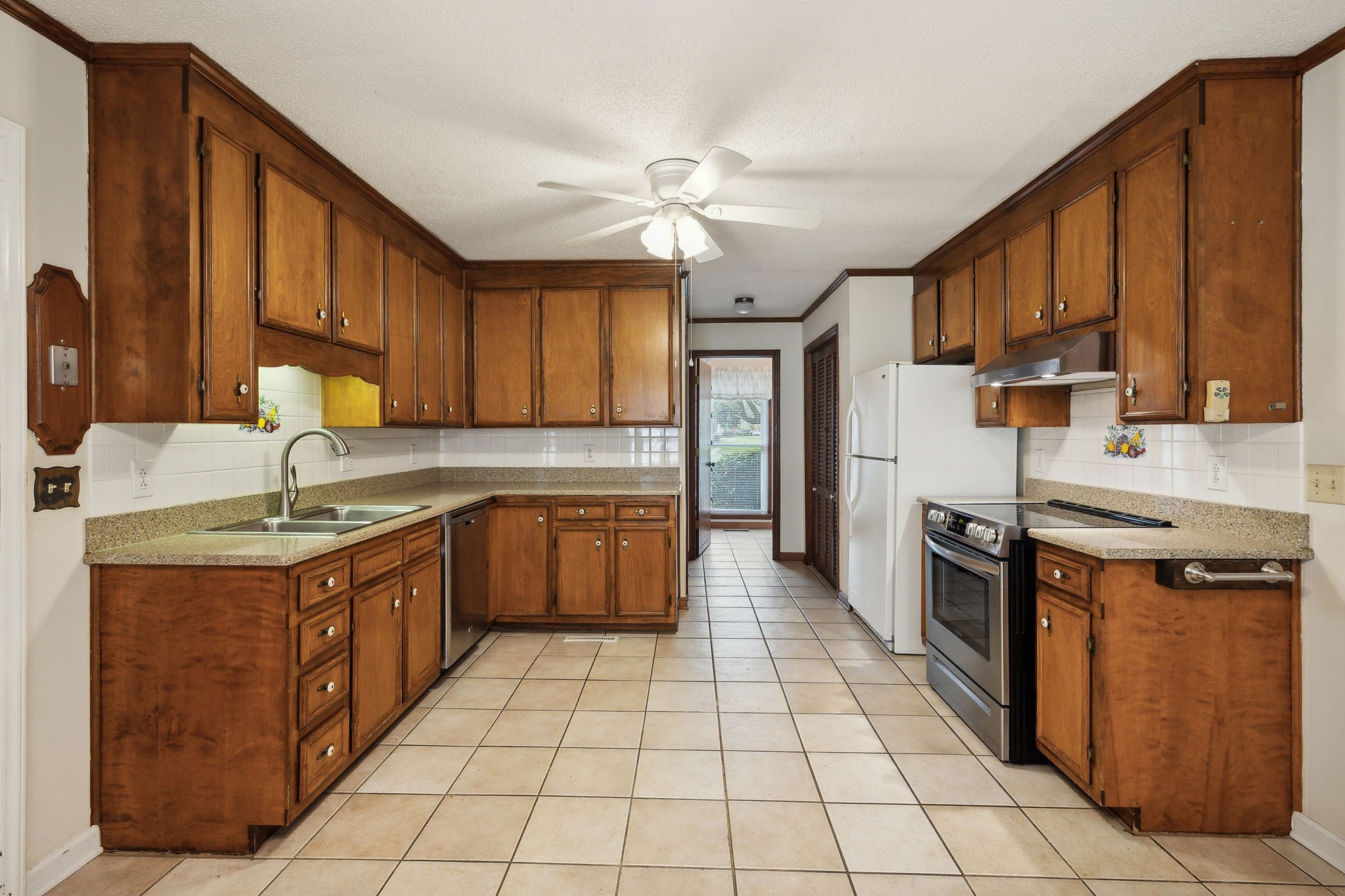 4068 Confederate Road Murfreesboro, TN 37128 - Photo 3 of 53 Kitchen is large with lots of cabinet space and separate pantry closet! There are updated counters, tile flooring and appliances (Dishwasher, Stove & Refrigerator) remain!