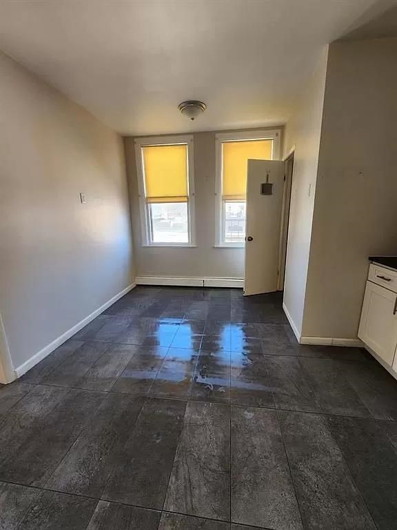 14 Cooper Street, Unit 2F Bayonne, NJ 07002 - Photo 3 of 6 an empty room with windows and closet