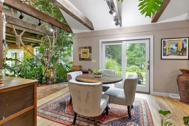 a dining room with furniture and window