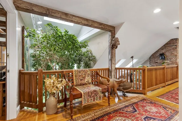 a view of a balcony with chairs and wooden floor
