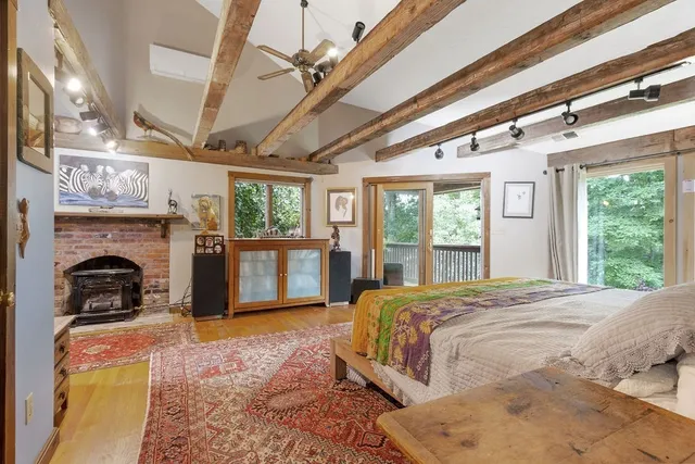 a bed room with a bed and fireplace