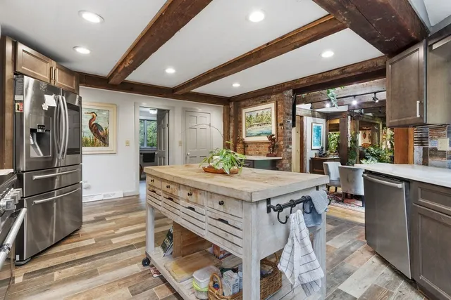 a kitchen with stainless steel appliances granite countertop a stove and a refrigerator