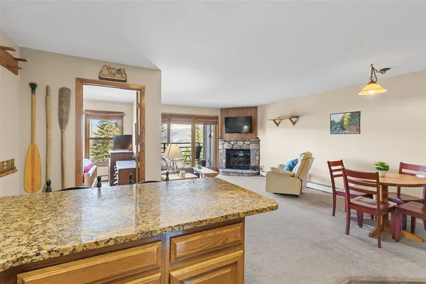 a living room with dining room and wooden floor