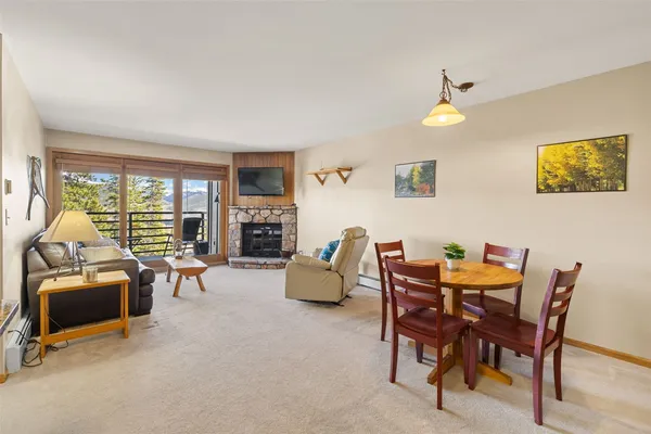 a dining room with furniture and a floor to ceiling window
