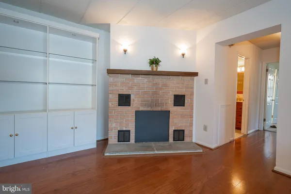 an empty room with cabinet and wooden floor