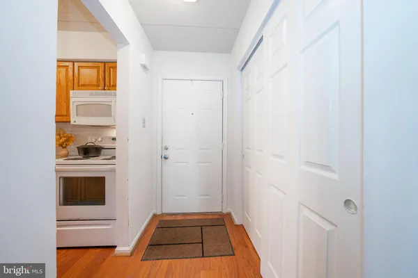 a view of a kitchen from a hallway