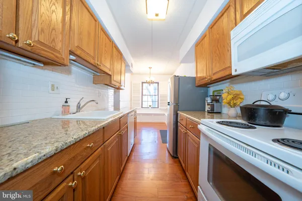 a kitchen with stainless steel appliances granite countertop a lot of counter space and a sink