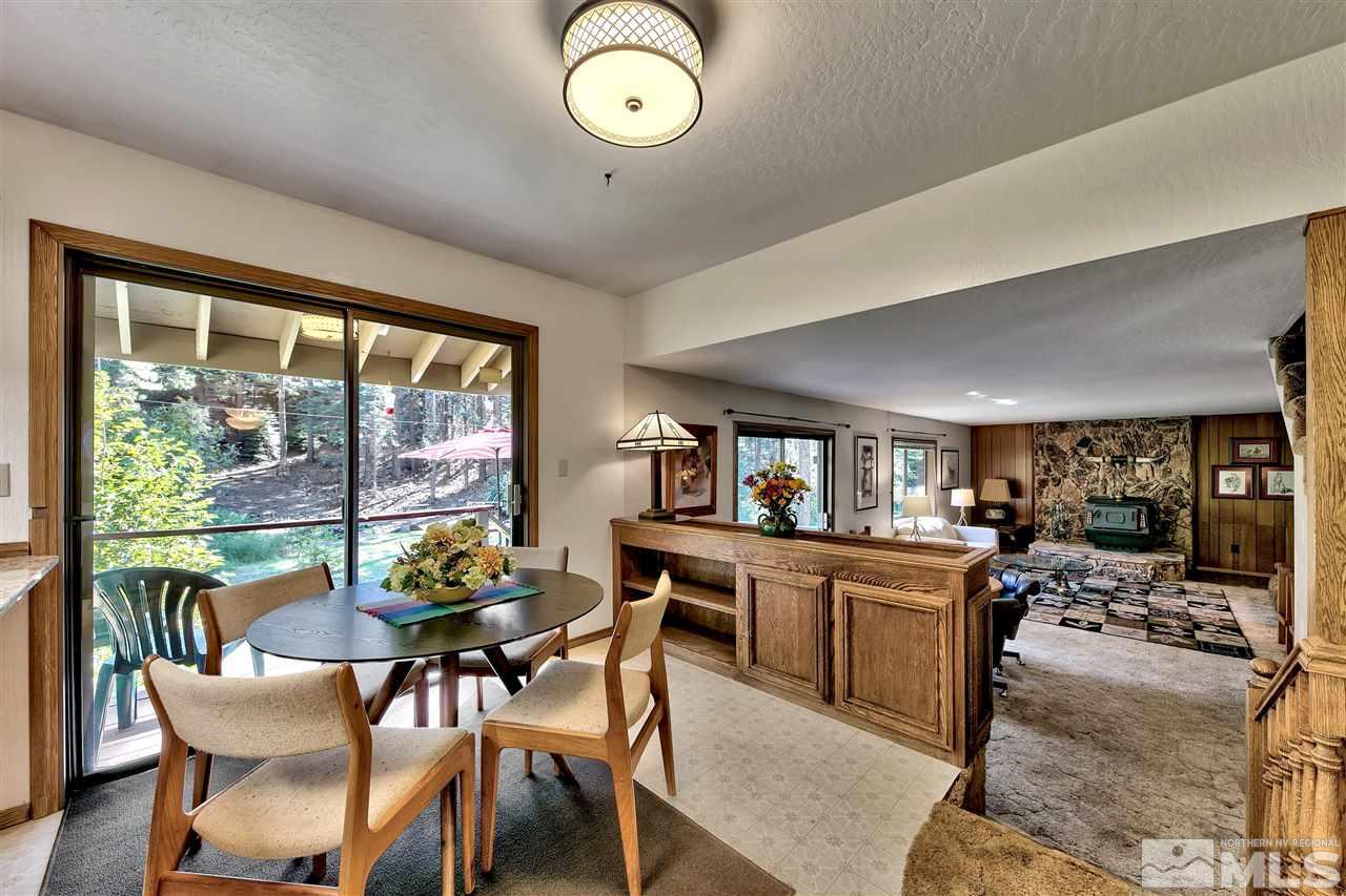 361 Summit Drive Stateline, NV 89449 - Photo 17 of 35 a view of a dining room and livingroom with furniture wooden floor and a rug