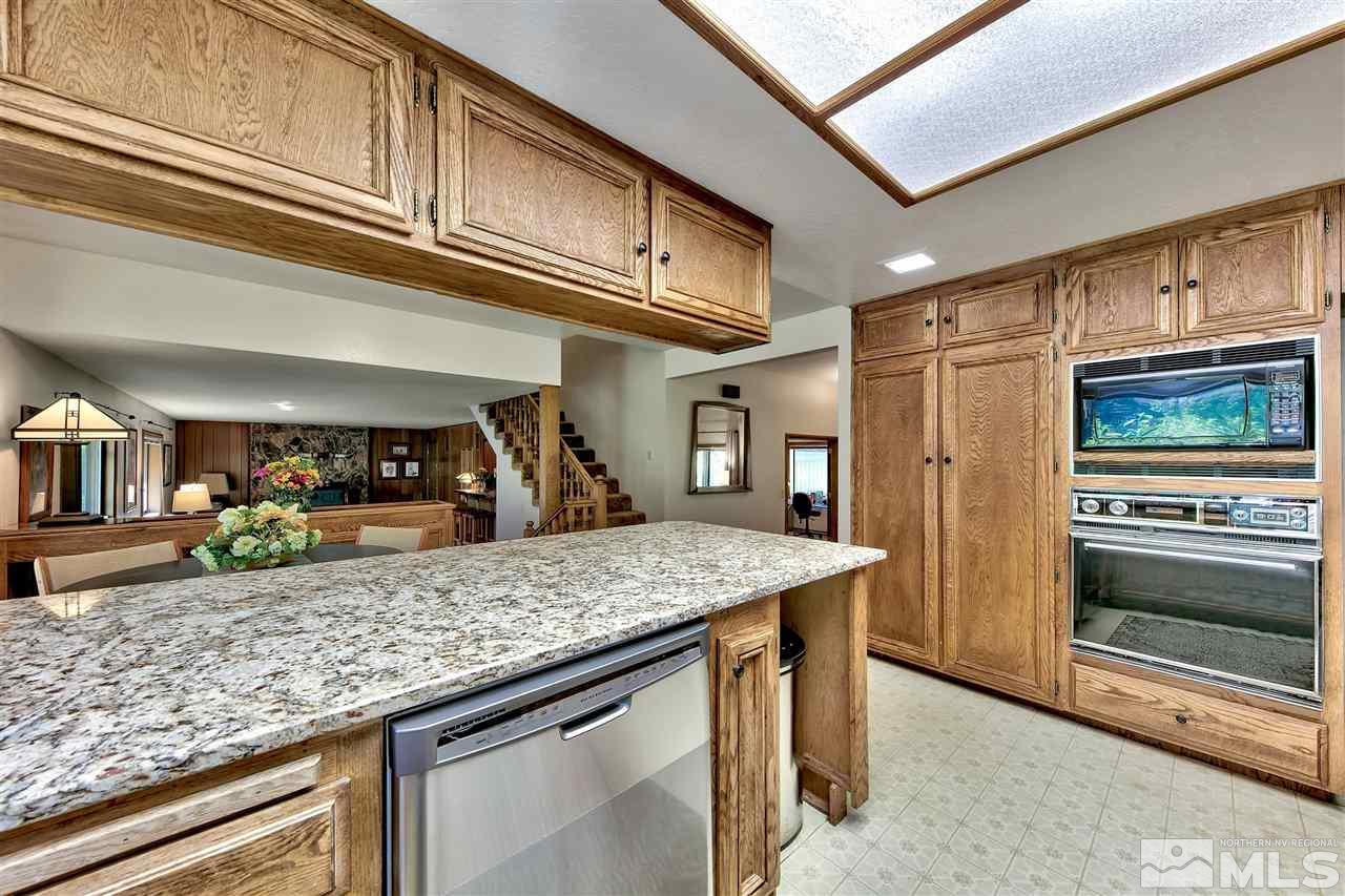 361 Summit Drive Stateline, NV 89449 - Photo 22 of 35 a kitchen with granite countertop counter top space cabinets and stainless steel appliances