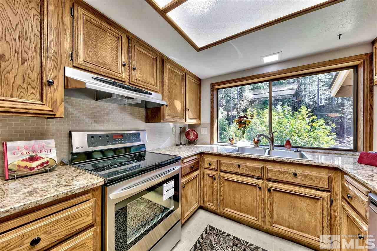 361 Summit Drive Stateline, NV 89449 - Photo 23 of 35 a kitchen with stainless steel appliances granite countertop a stove a sink and cabinets