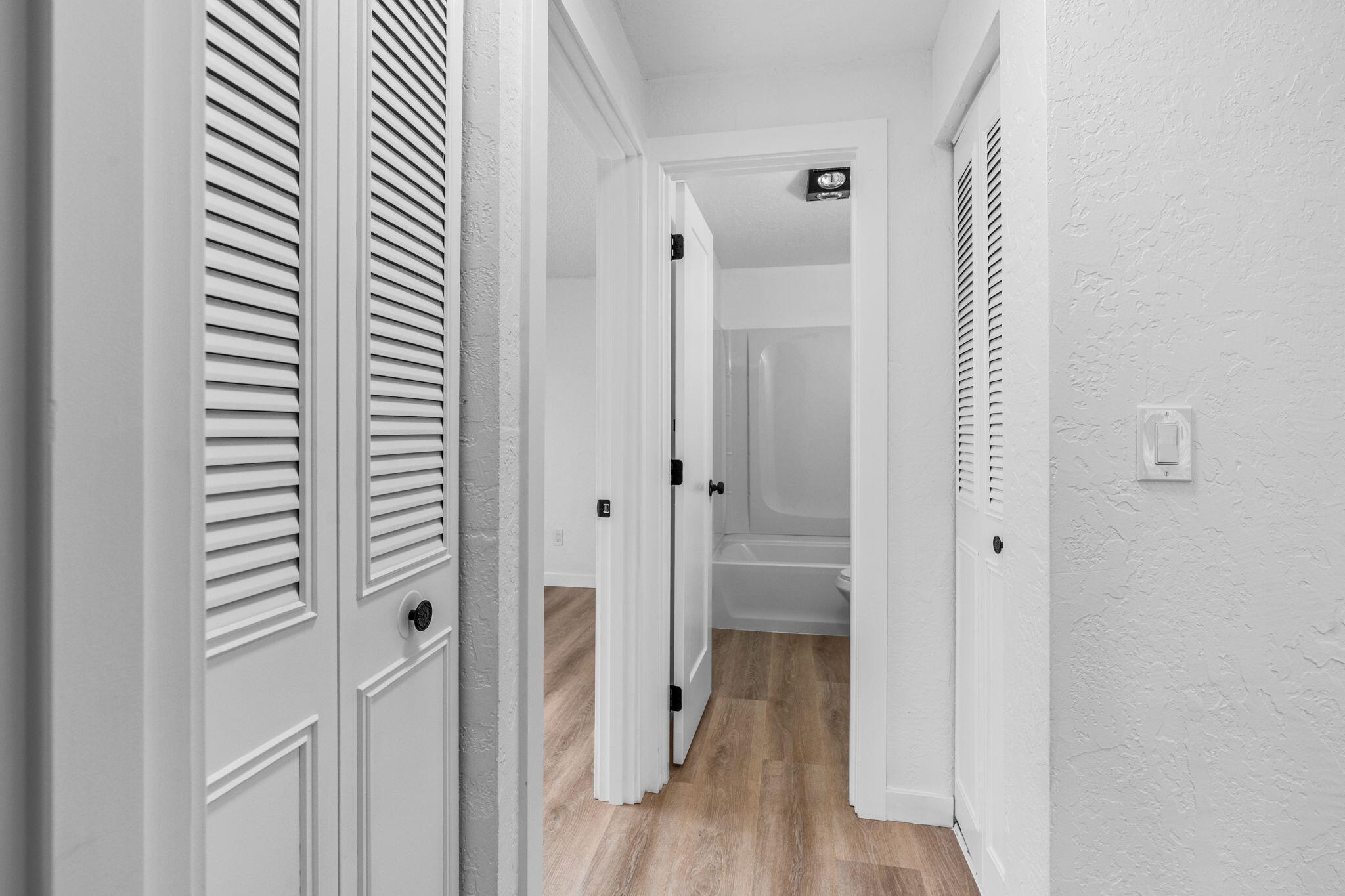 1700 Northeast Wells Acres Road, Unit 25 Bend, OR 97701 - Photo 19 of 25 a view of hallway with wooden floor