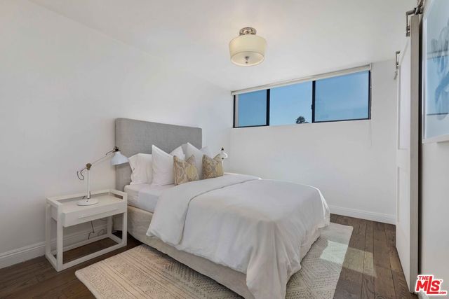 a bedroom with a bed and a night stand