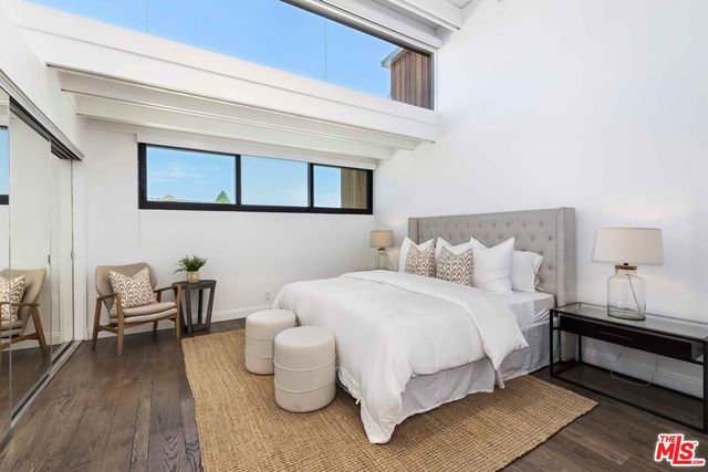 a bedroom with bed and a couch