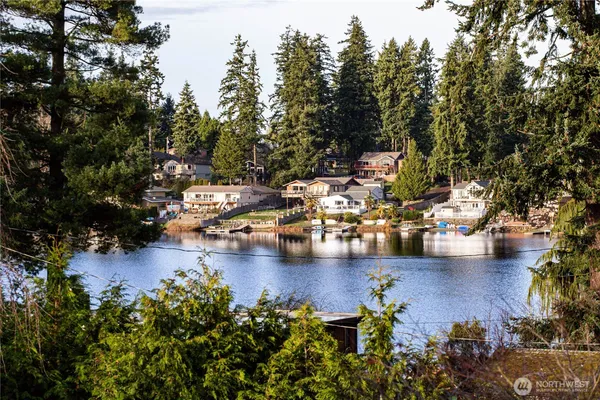 a view of a lake with boats and trees