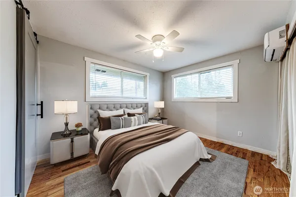 a bedroom with a bed and a chandelier