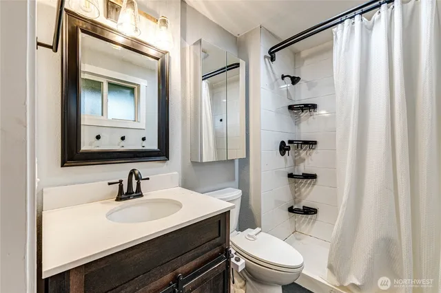 a bathroom with a sink toilet and shower