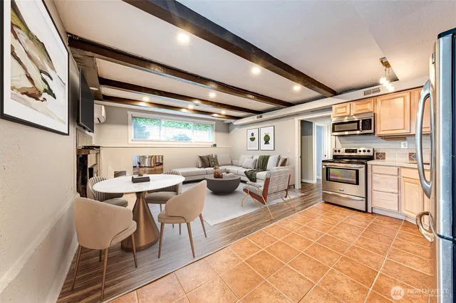 a living room with stainless steel appliances kitchen island granite countertop furniture and a kitchen view