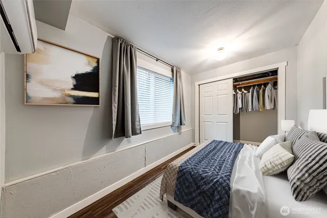 a bedroom with a large bed and a window