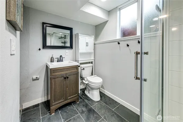 a bathroom with a toilet sink and shower