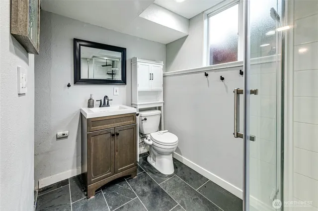 a bathroom with a toilet sink and shower