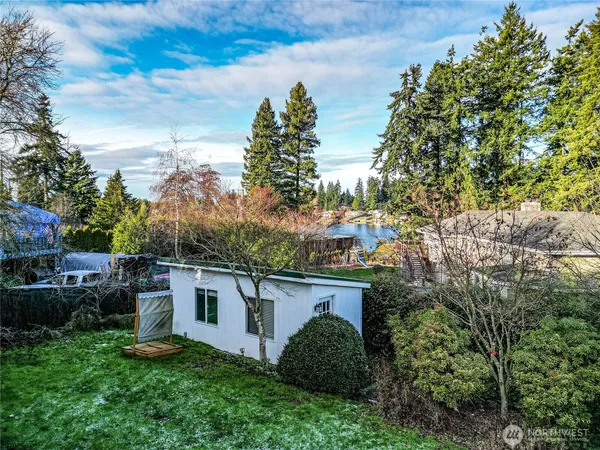 a view of a house with a yard and a tree