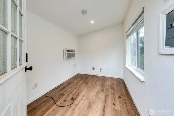 a view of a room with wooden floor and windows