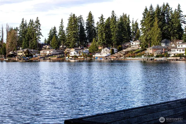 a view of a lake with boats and trees