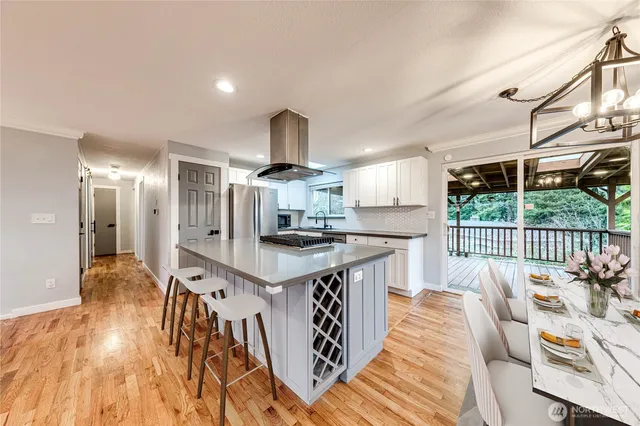 a kitchen with stainless steel appliances granite countertop a sink stove and wooden floor