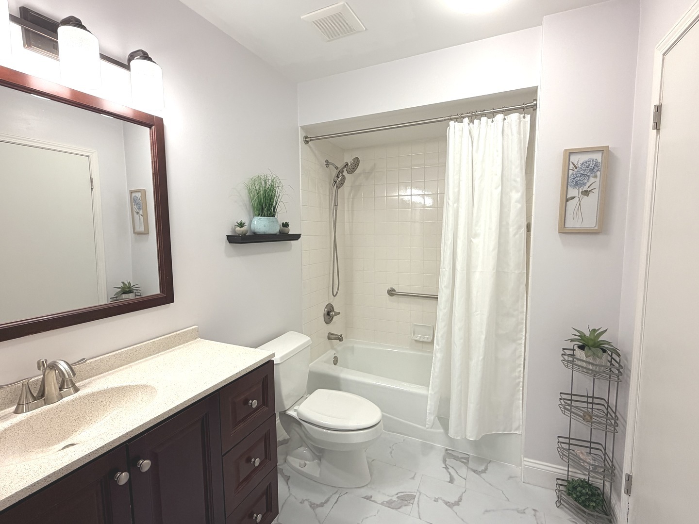 300 East Dundee Road, Unit 102A Buffalo Grove, IL 60089 - Photo 19 of 27 a bathroom with a granite countertop sink toilet a large mirror a shower and a bathtub