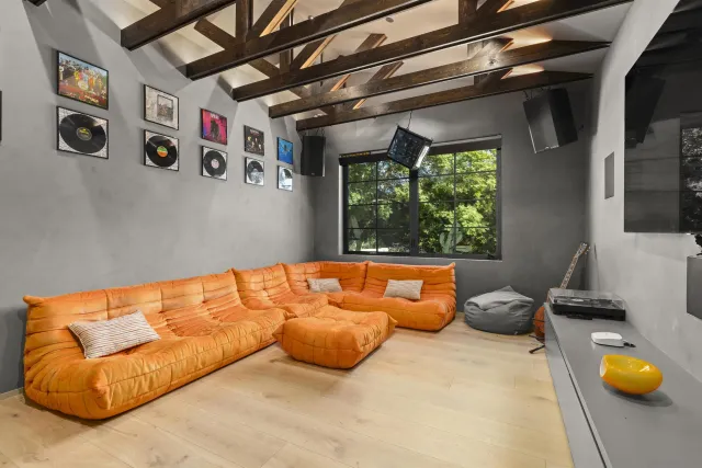 a living room with blue painted wall with furniture