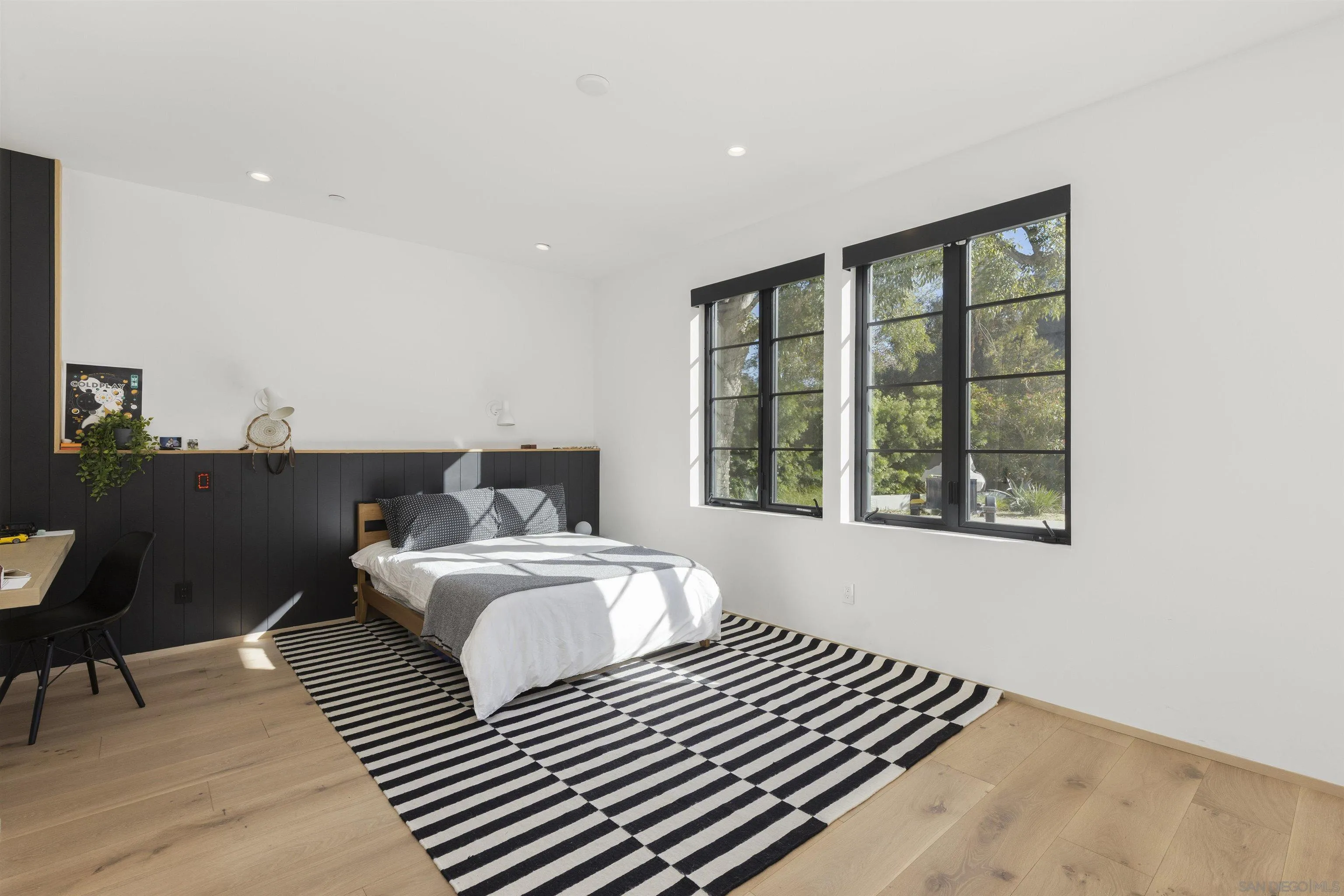 4874 Sun Valley Road Del Mar, CA 92014 - Photo 20 of 42 a bedroom with a bed and wooden floor