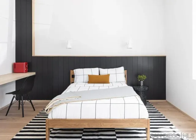 a bedroom with a bed and a table