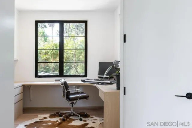 a bathroom with a sink a window and a mirror
