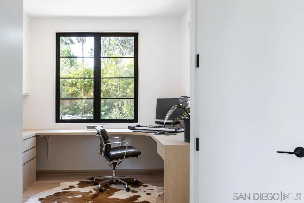 4874 Sun Valley Road Del Mar, CA 92014 - Photo 23 of 42 a bathroom with a sink a window and a mirror