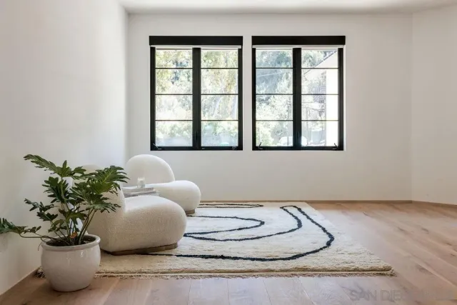 a view of a room with gym equipment and a large window