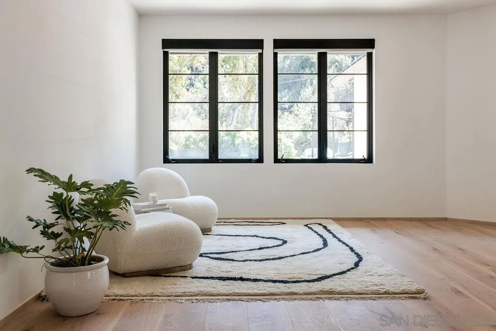 4874 Sun Valley Road Del Mar, CA 92014 - Photo 26 of 42 a white vase with white and yellow flowers