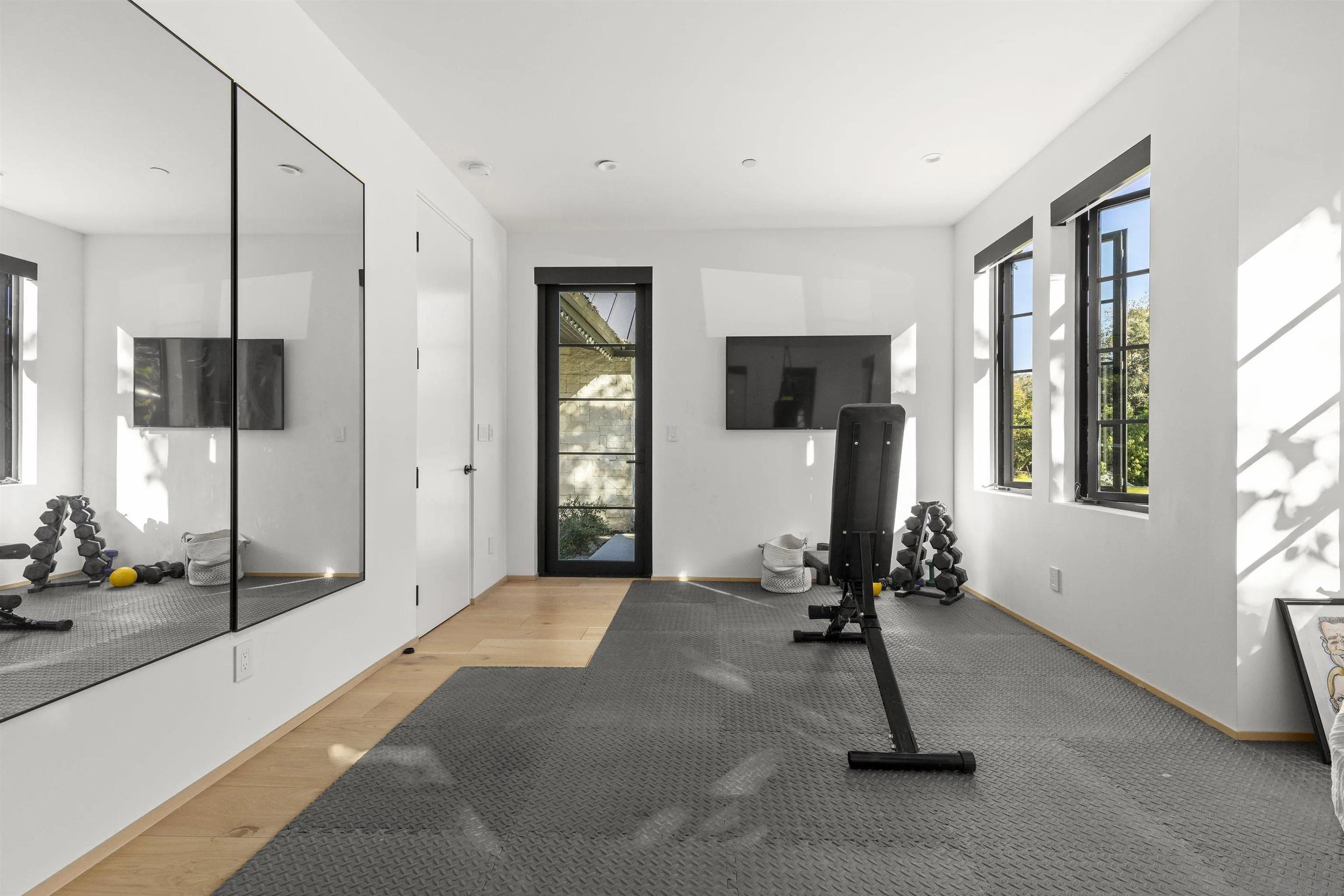 4874 Sun Valley Road Del Mar, CA 92014 - Photo 27 of 42 a view of a room with gym equipment and a large window