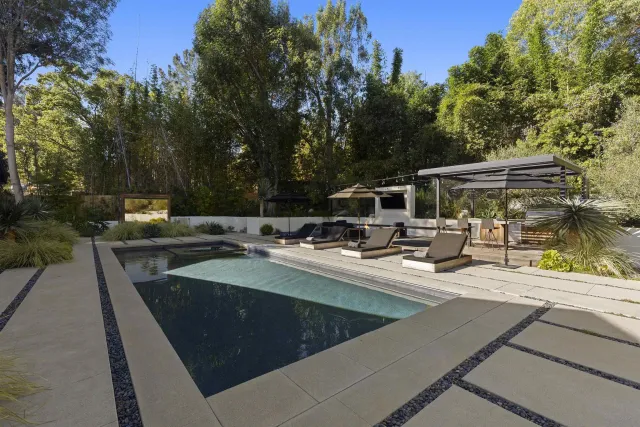 a view of a swimming pool with a lounge chairs