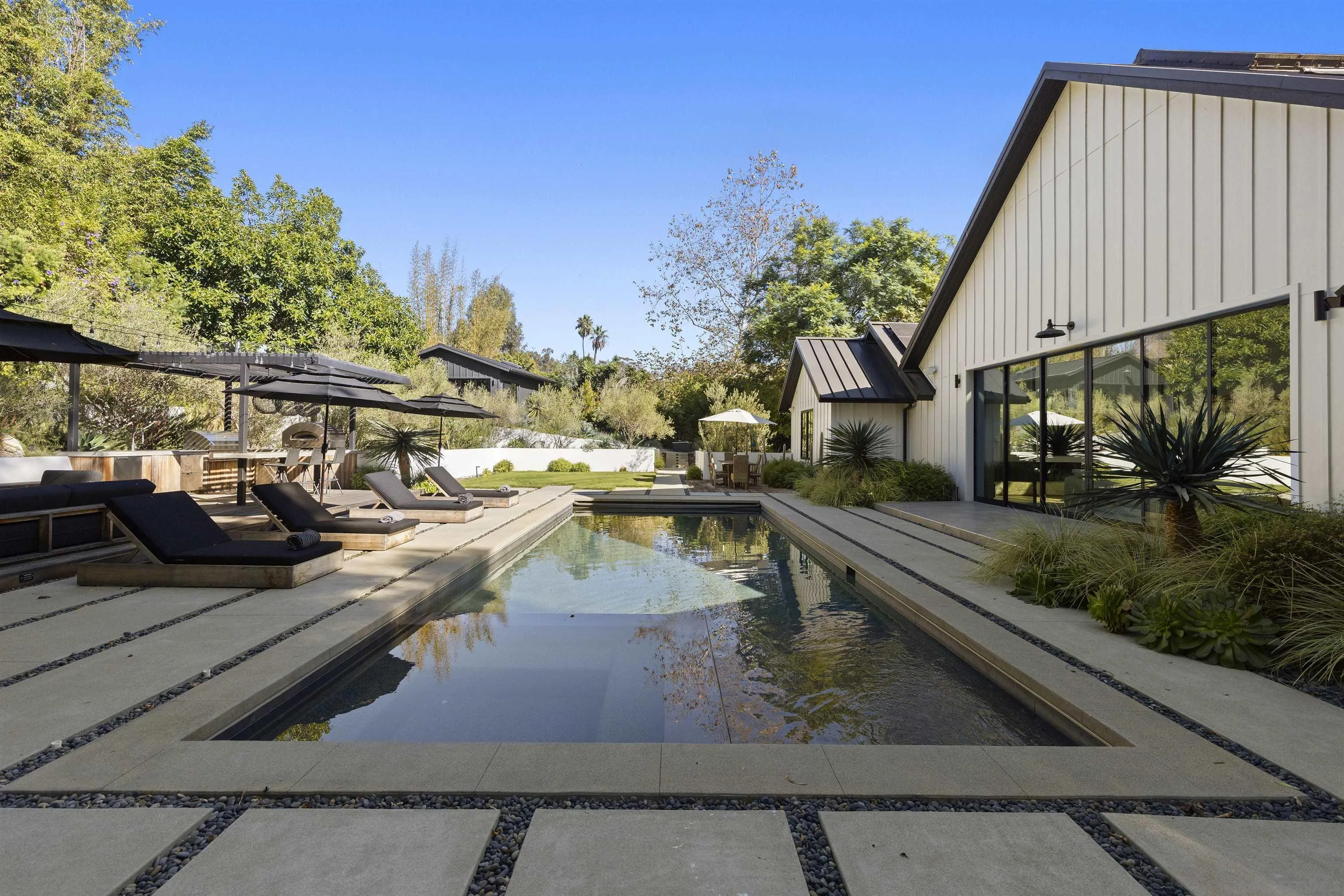 4874 Sun Valley Road Del Mar, CA 92014 - Photo 29 of 42 a view of a swimming pool with a lounge chairs