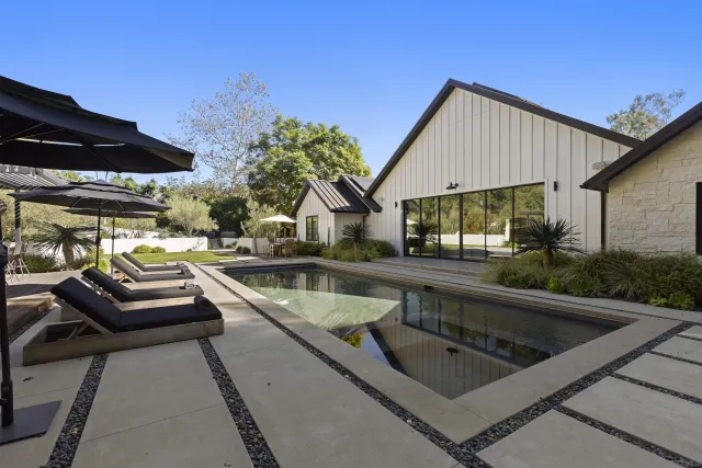a view of backyard with outdoor seating and trees