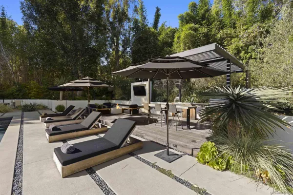 a view of a patio with couches and a table and chairs with wooden floor