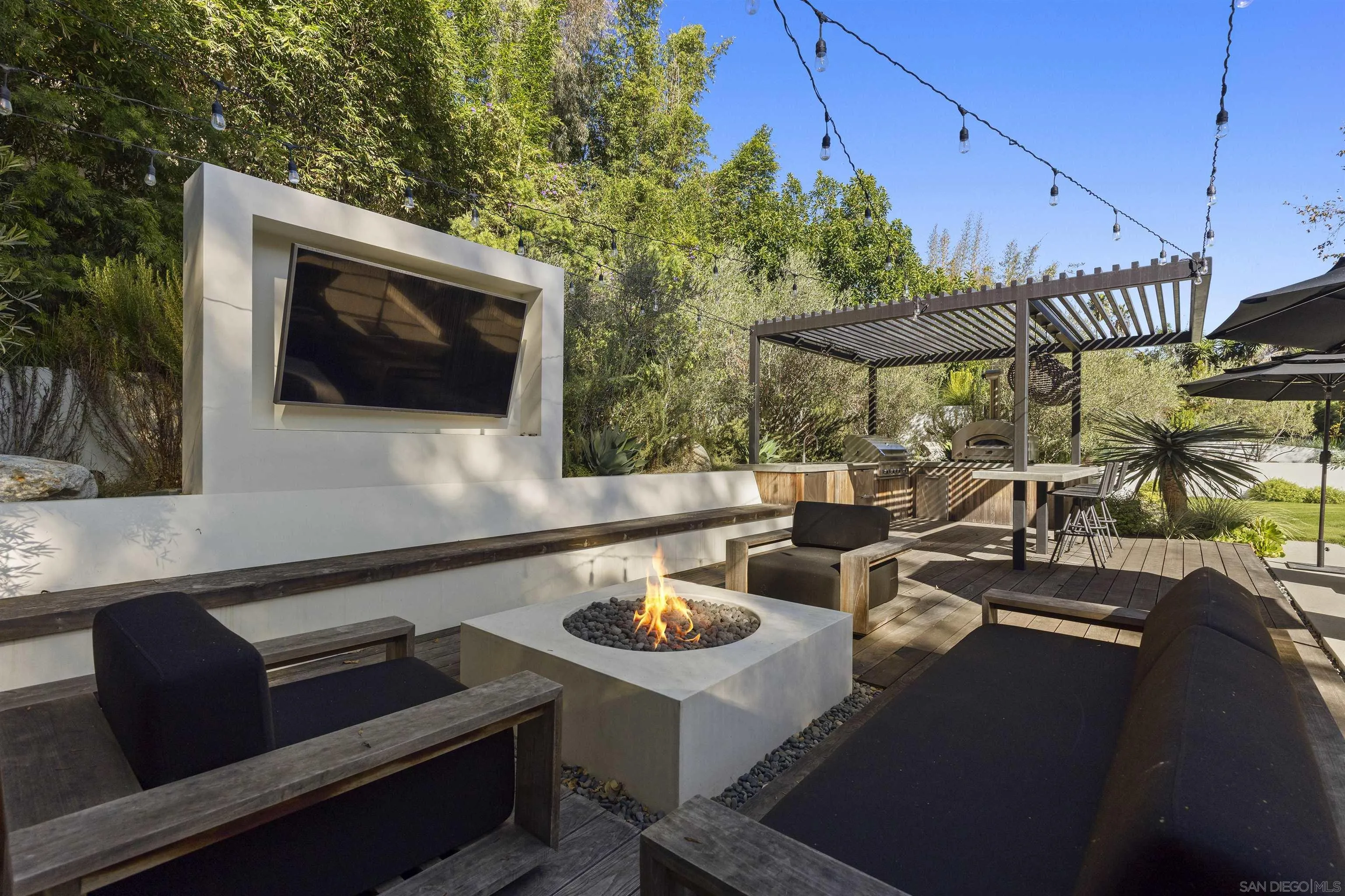 4874 Sun Valley Road Del Mar, CA 92014 - Photo 33 of 42 a terrace with outdoor seating and trees