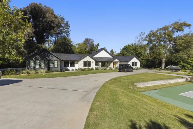 a view of house with outdoor space and sitting area