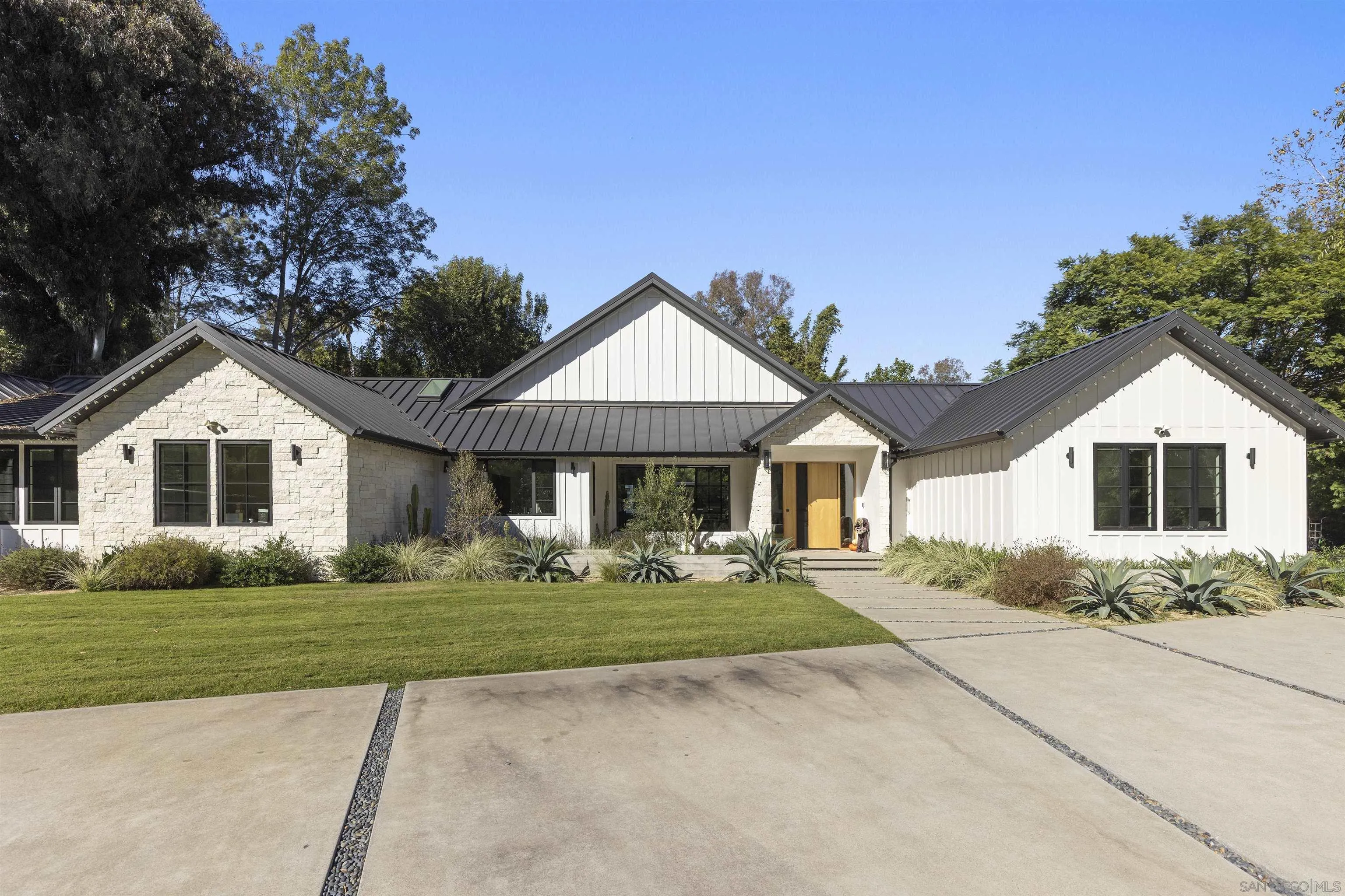 4874 Sun Valley Road Del Mar, CA 92014 - Photo 5 of 42 a front view of a house with a yard