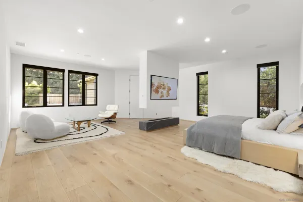 a bedroom with a bed and glass window