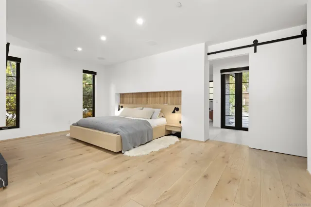 a bedroom with a large bed and a window