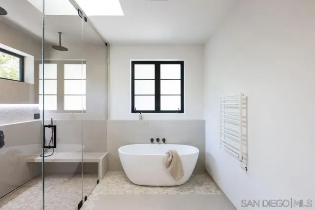 a bathroom with a bathtub and window