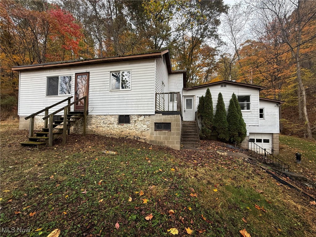 4589 Harmon Creek Road Colliers, WV 26035 - Photo 5 of 26 View of front of house with stairway and an attached garage