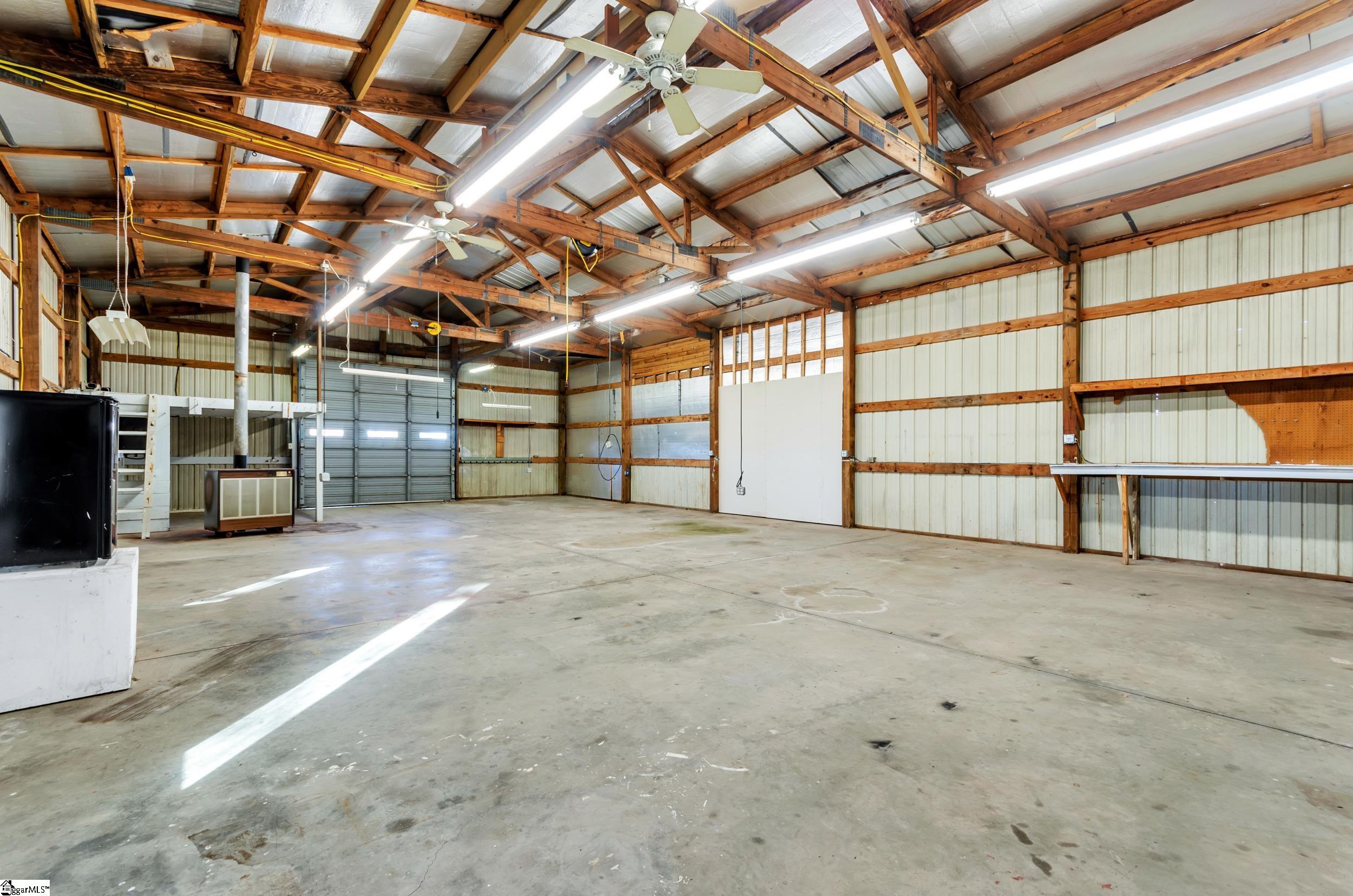 3180 Highway 357 Lyman, SC 29365 - Photo 42 of 50 Fireplace and new ventilation fan, small refrigerator, storage loft, 15 foot roll-up door, drop air compressor & drop power with multiple plugs.