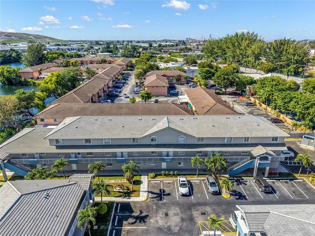 an aerial view of a house with swimming pool and outdoor seating